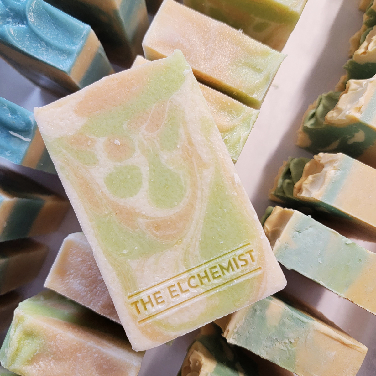 The Elcemist - Gilded Pear Soap sitting on rows of soaps
